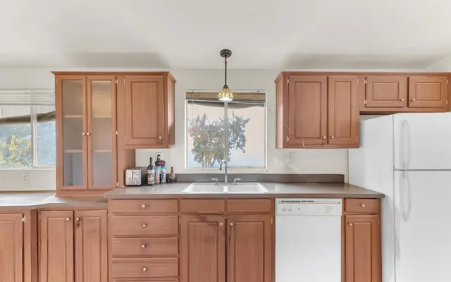 a kitchen with granite countertop a sink cabinets and window