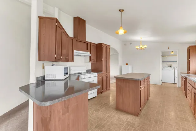 a kitchen with refrigerator and cabinets