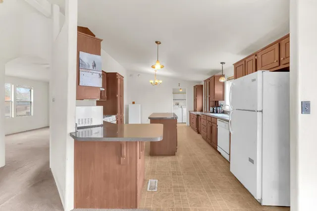 a kitchen with refrigerator and cabinets