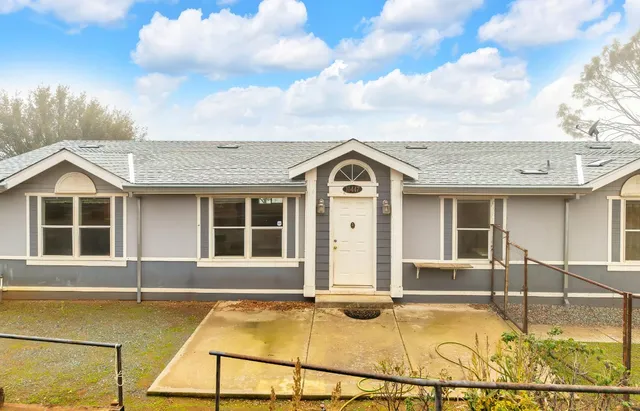 a view of a house with pool and a yard