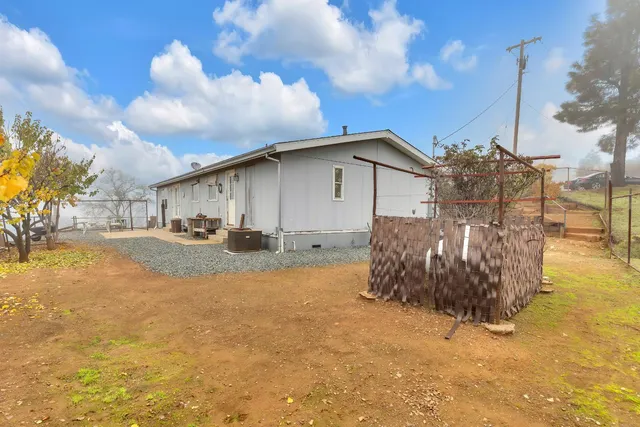 a view of a backyard with sitting area
