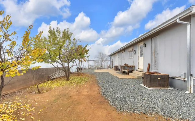 a view of a house with a backyard and balcony