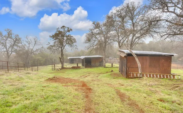 a backyard of a house with table and chairs