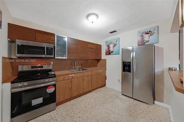 a stove top oven sitting inside of a kitchen