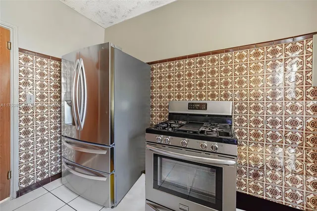 a stove top oven sitting inside of a kitchen