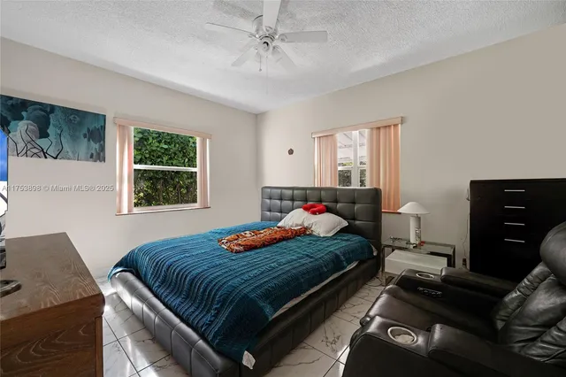 a bedroom with a bed dresser and a window