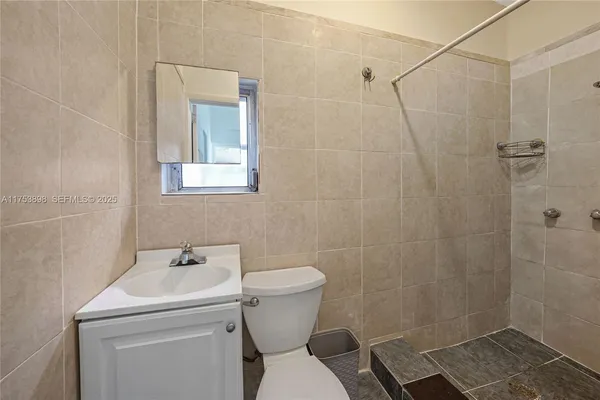 a bathroom with a glass shower door