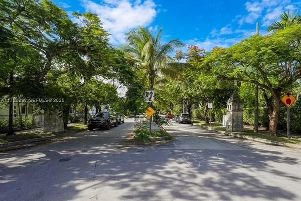 a view of a brick house with a large windows and a large tree