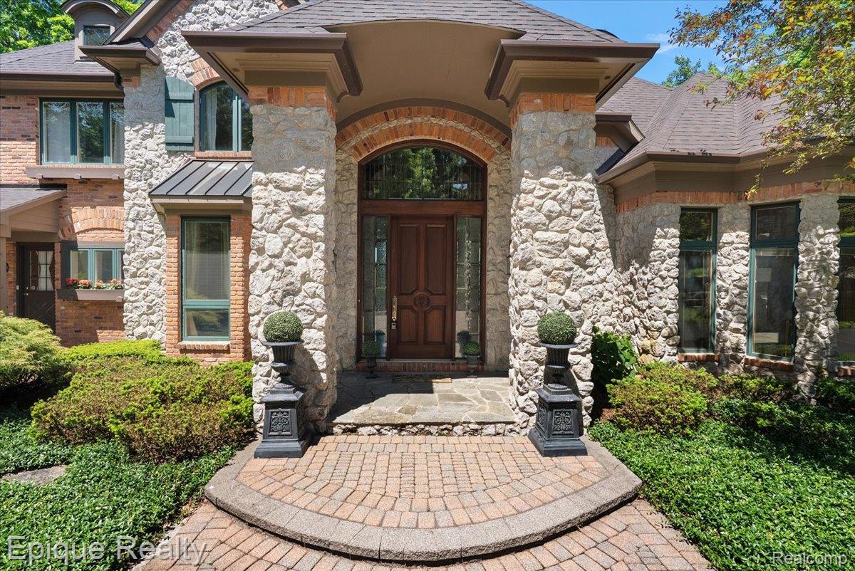 7662 Devins Ridge Clarkston, MI 48348 - Photo 5 of 81 Stone and brick facade with a prominent arched entry