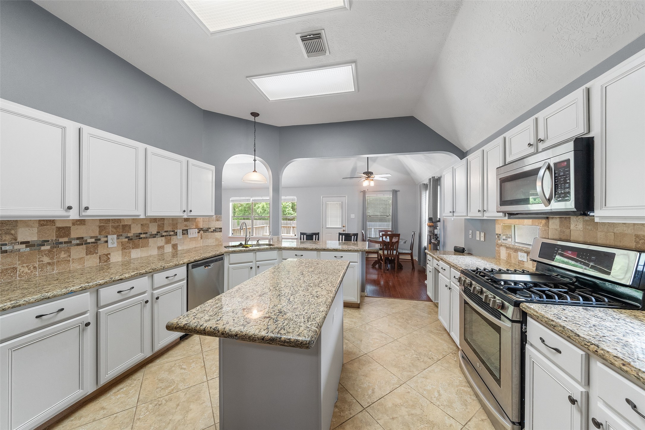 19718 Teller Boulevard Spring, TX 77388 - Photo 17 of 47 a kitchen with stainless steel appliances granite countertop a stove and a sink