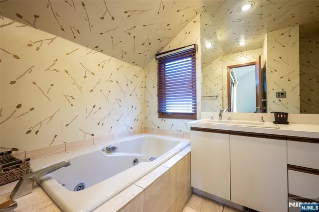 a bathroom with a bathtub and a sink