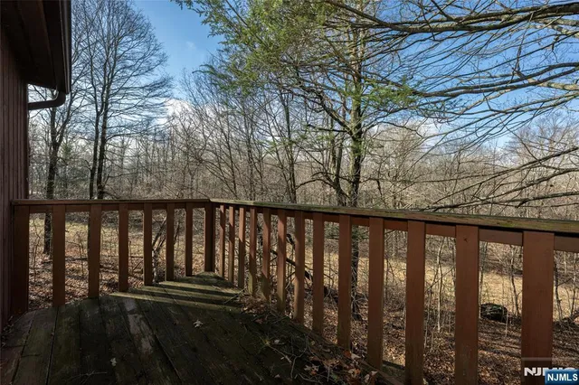 a balcony with wooden floor and outdoor space