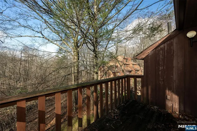 a view of a balcony with wooden fence and floor