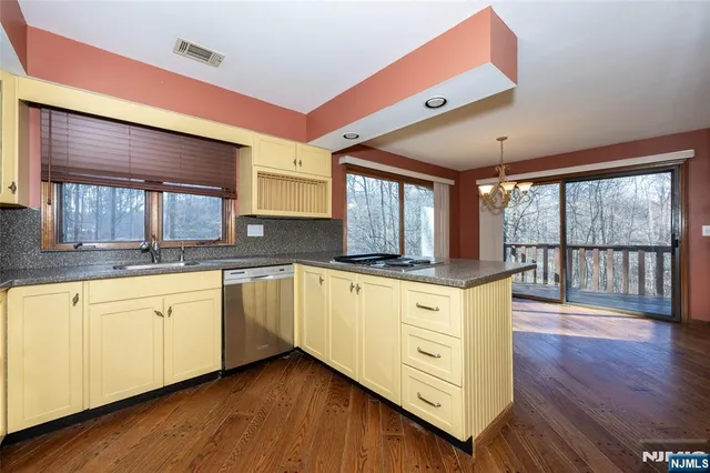 a kitchen with a refrigerator sink and cabinets