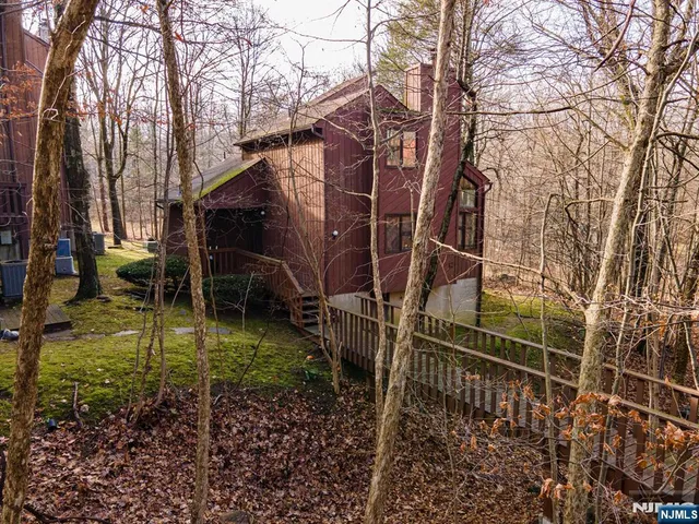 a aerial view of a house with a yard and trees