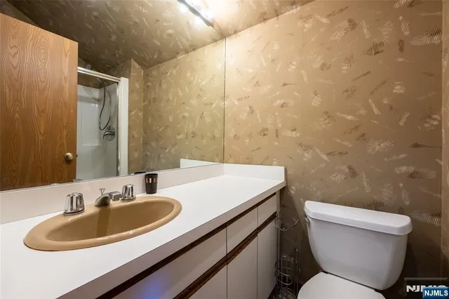 a bathroom with a sink a toilet and a mirror