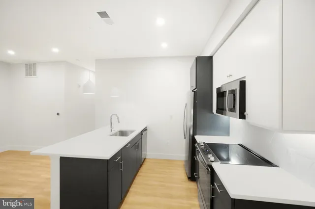 a kitchen with a sink and a refrigerator