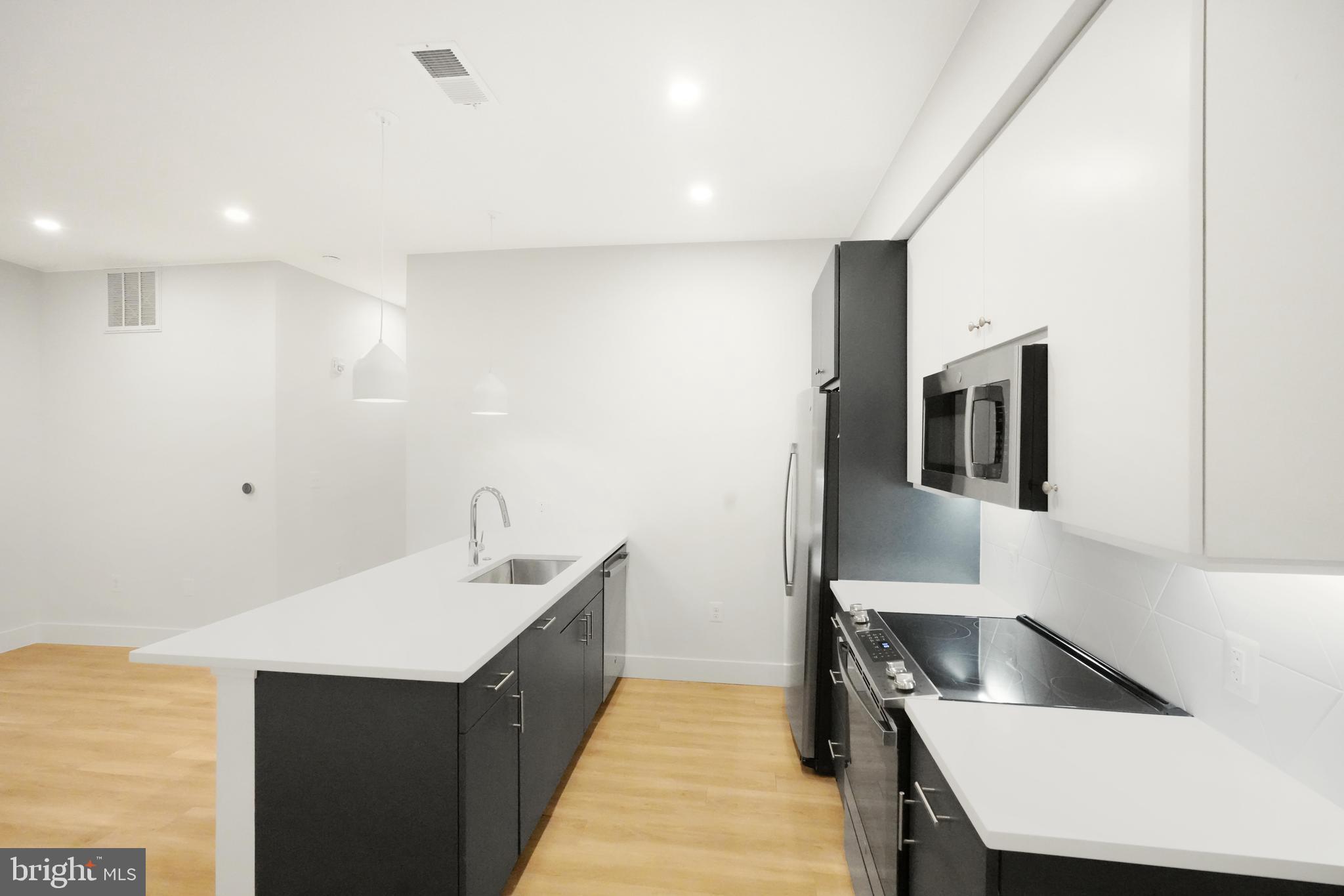 a kitchen with a sink and a refrigerator