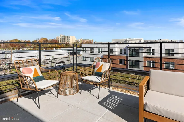 a terrace with outdoor seating and city view