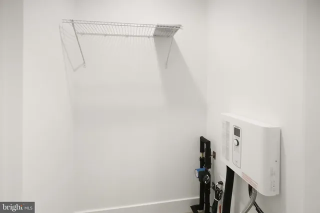 a view of closet with wooden floor