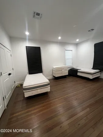 a living room with furniture wooden floor and a table