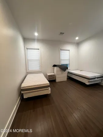 a bedroom with two beds and a desk
