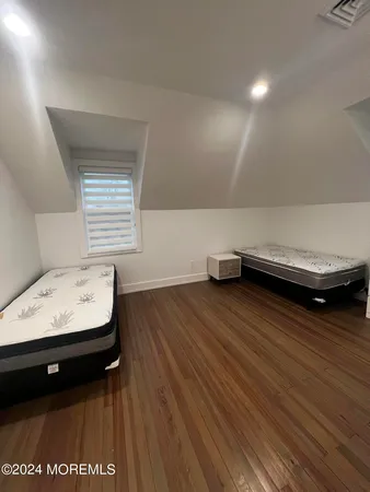 a living room with hard wood floors and a wooden floor