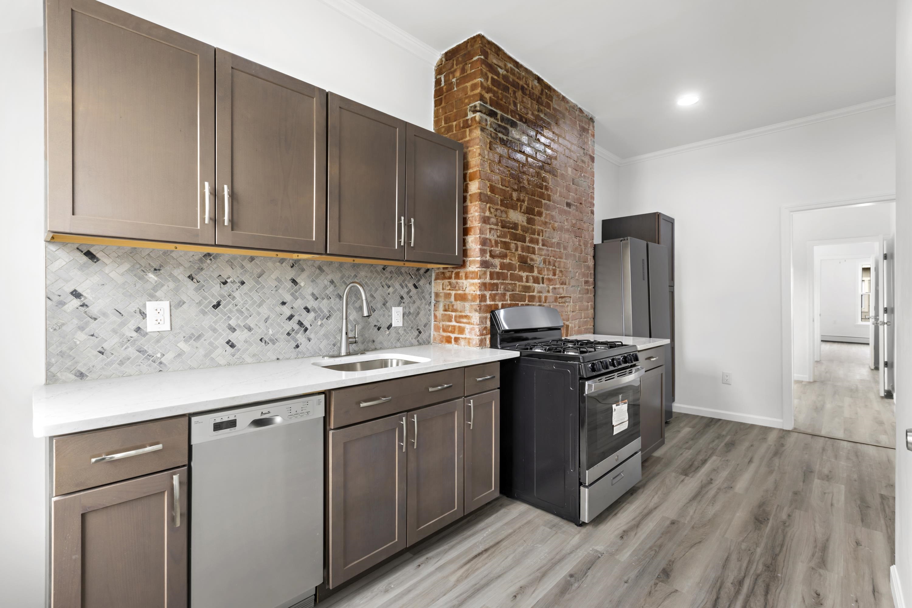 a kitchen with stainless steel appliances granite countertop a sink stove and refrigerator