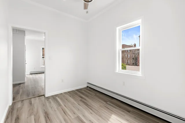 an empty room with a bench and closet