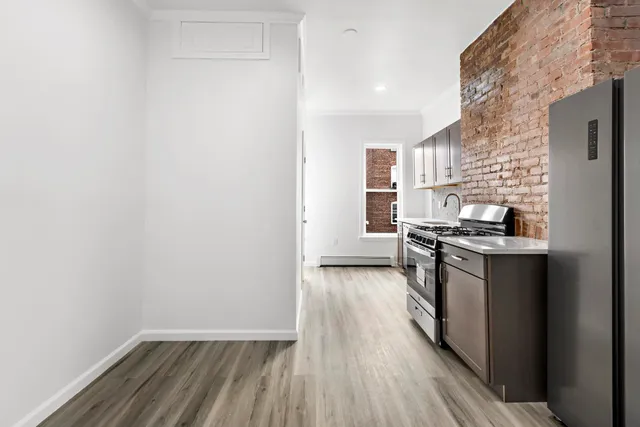 a kitchen with granite countertop a sink and a stove top oven