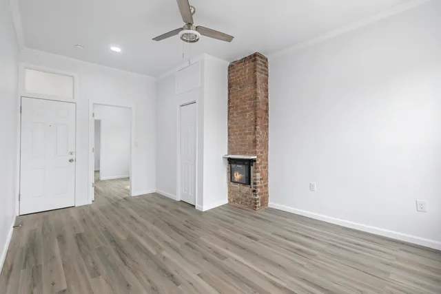 wooden floor in an empty room with a window