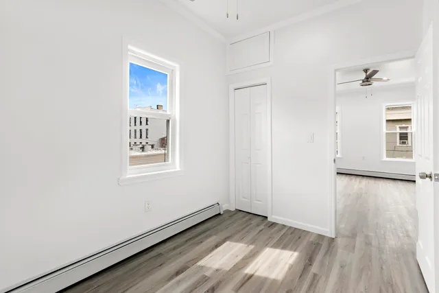 a view of a room with wooden floor and window