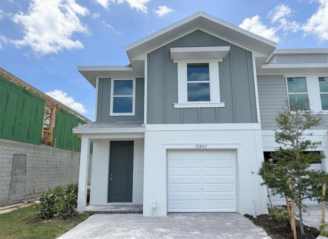 12957 Southwest Forli Way Port St. Lucie, FL 34987 - Photo 1 of 31 a front view of a house with a yard