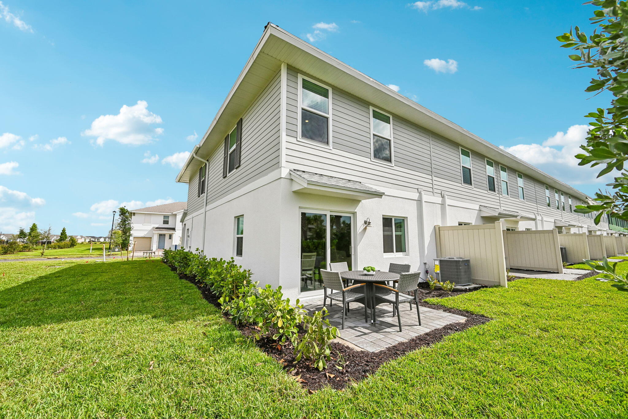 12957 Southwest Forli Way Port St. Lucie, FL 34987 - Photo 26 of 31 a view of a house with backyard porch and sitting area