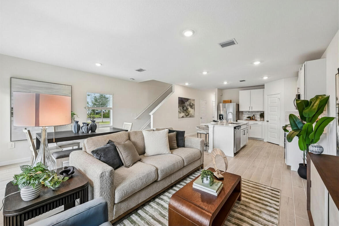 12957 Southwest Forli Way Port St. Lucie, FL 34987 - Photo 10 of 31 a living room with furniture kitchen and a potted plant