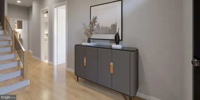 a view of a hallway with wooden floor and entryway
