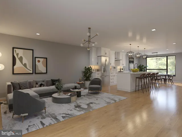 a living room with furniture and kitchen view