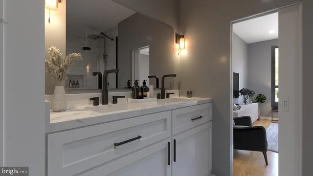a view of a hallway with a livingroom and a bathroom with sink
