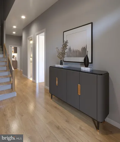 a view of a hallway with wooden floor and staircase