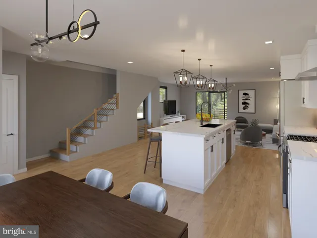 a view of living room kitchen with furniture and wooden floor