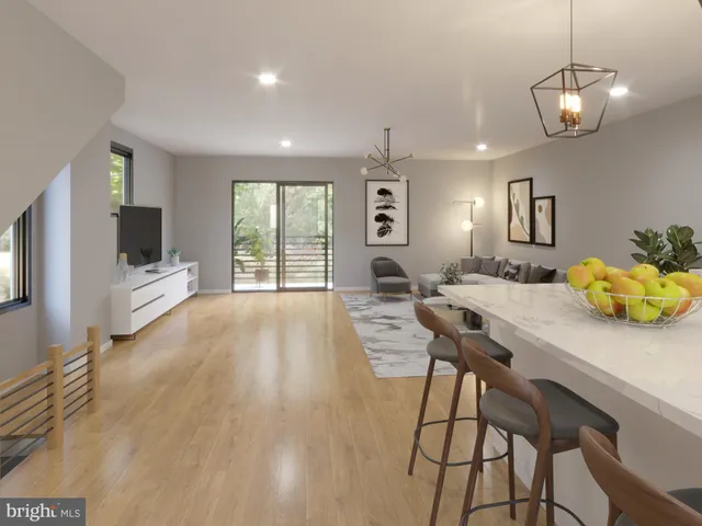 a view of a dining room with furniture a livingroom and chandelier