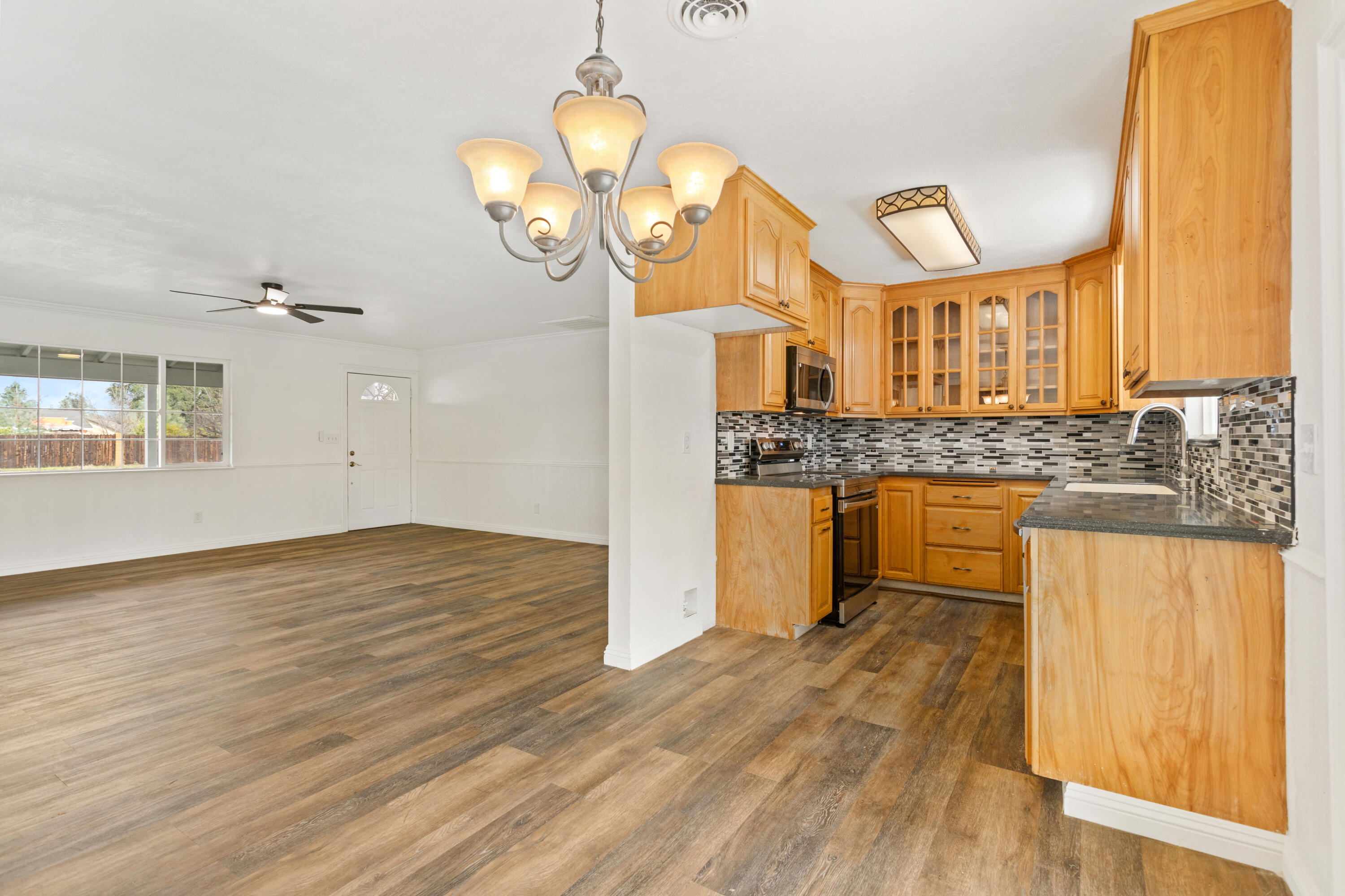 6973 Happy Valley Road Anderson, CA 96007 - Photo 16 of 36 a view of a kitchen counter space and wooden floor