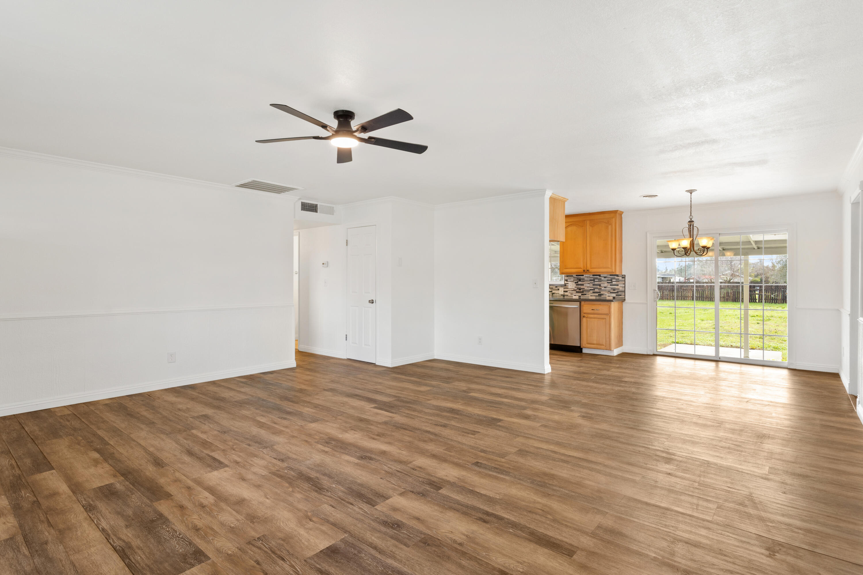 6973 Happy Valley Road Anderson, CA 96007 - Photo 19 of 36 a view of empty room with wooden floor and fan