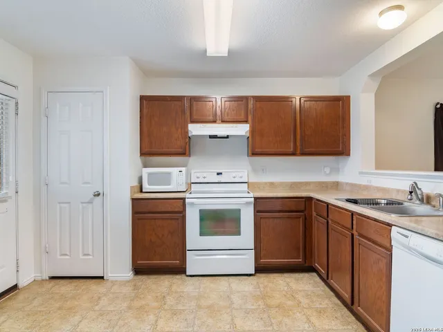 a kitchen with stainless steel appliances granite countertop a stove and a sink