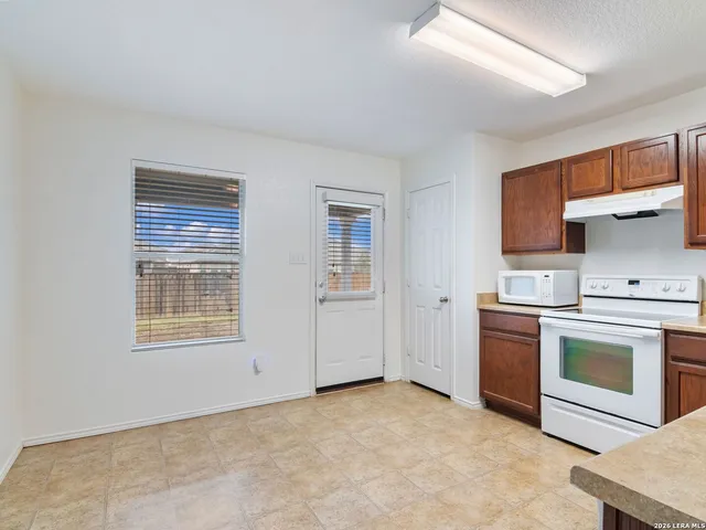 a kitchen with a stove oven and a refrigerator