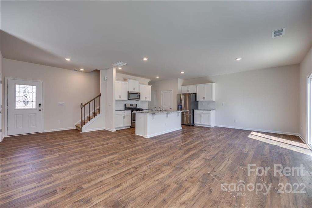 587 King Clover Lane Clover, SC 29710 - Photo 5 of 25 a view of empty room with wooden floor and kitchen