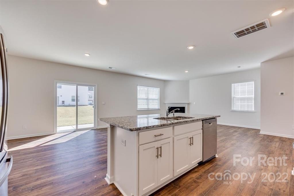 587 King Clover Lane Clover, SC 29710 - Photo 7 of 25 a kitchen with granite countertop a sink and cabinets with wooden floor