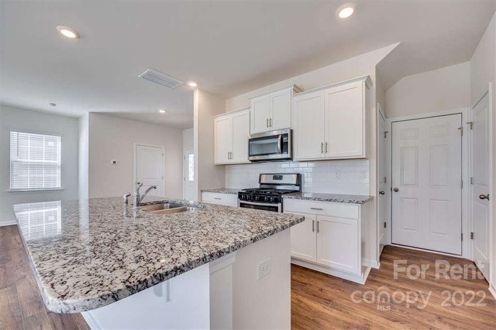 587 King Clover Lane Clover, SC 29710 - Photo 8 of 25 a kitchen with sink stove and refrigerator