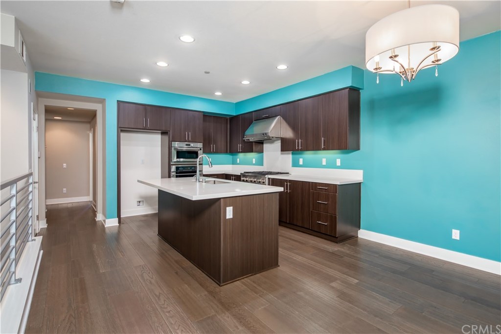 61 Gramercy Irvine, CA 92612 - Photo 10 of 21 a kitchen with stainless steel appliances granite countertop a sink a stove a refrigerator and a microwave