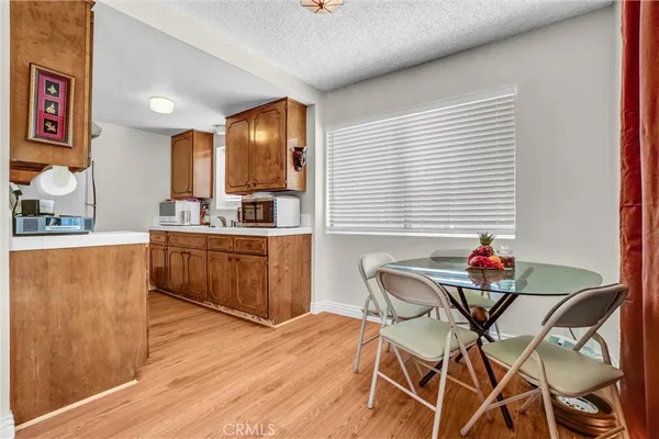 a kitchen that has a sink a stove and a wooden floor